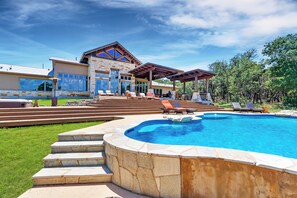 A modern house with a swimming pool, outdoor seating, and a stone staircase leading to the entrance. - C L Ranch - Luxury estate with pool, hot tub, and outdoor kitchen! (Fischer)