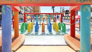 A water play area with colorful structures and a pool in the background. - Gorgeous View Oceanfront Condo w/ Hug Sundeck Balcony (Myrtle Beach)