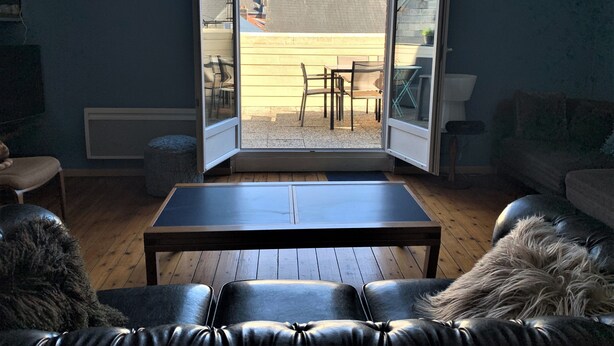 A living room with a large sliding glass door leading to an outdoor patio.