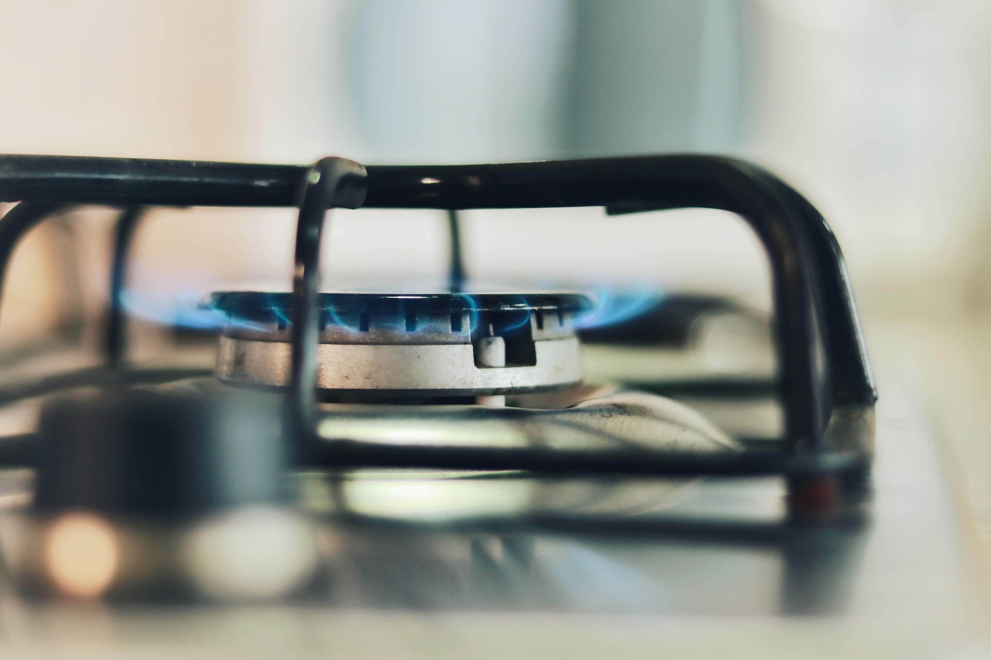 A gas stove with a blue flame.