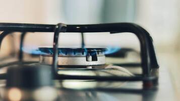 A gas stove with a blue flame.
