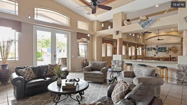 A spacious living room with a fireplace, a dining area, and a kitchen with bar seating. - Resort-like amenities and perfectly located Scottsdale condo (Scottsdale)