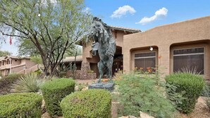 A building with a large horse statue in front, surrounded by well-maintained landscaping and a clear blue sky. - Resort-like amenities and perfectly located Scottsdale condo (Scottsdale)