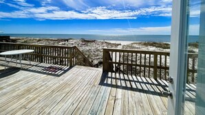A wooden deck with a view of the beach and ocean. - Cabana Beach House (Gulf Shores)