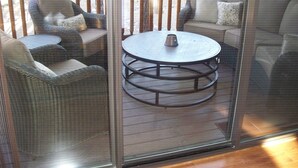 A covered outdoor seating area with wicker furniture and a round table. - FREE TORREON GOLF GREEN FEES  -  Designer Furnished Villa 3 night minimum     (Show Low)