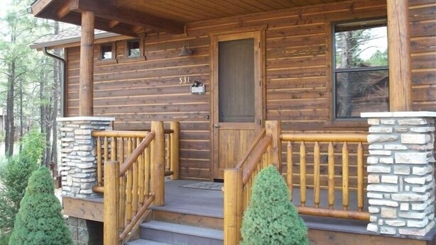 A wooden cabin with a stone foundation, a front door, and a number '531' on the wall. - FREE TORREON GOLF GREEN FEES  -  Designer Furnished Villa 3 night minimum     (Show Low)