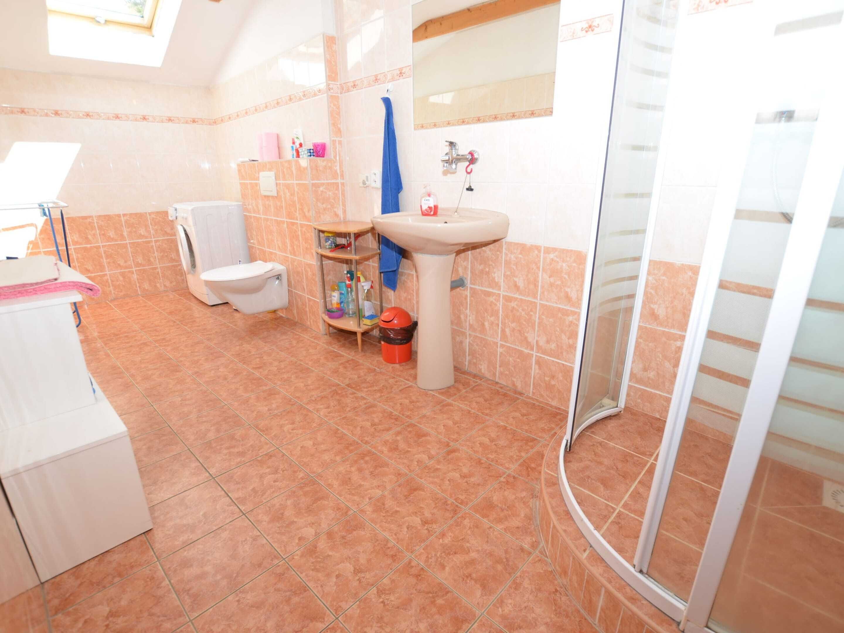A bathroom with a toilet, sink, and shower.