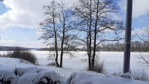 A snowy landscape with bare trees and a clear sky. - Holiday Home in Forest With Private Pool (Petrohrad)