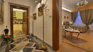 A spacious living area with a patterned floor, a chandelier, and a dining set. - Charming Prague Downtown Flat (Prague)