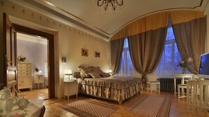 A bedroom with a bed, a desk, a chair, a dresser, and a radiator. - Charming Prague Downtown Flat (Prague)