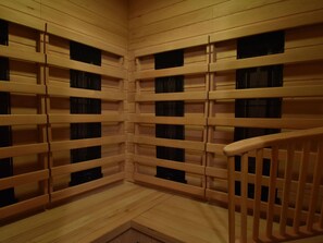 A corner of a room with wooden walls and a wooden railing. - Holiday Home With Garden in Quiet Mountain Village (Zlatá Olešnice)
