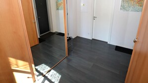 A room with dark wooden flooring, a white door, and a map on the wall. - Attractive Apartment in Rokytnice nad Jizerou near Ski Area (Rokytnice nad Jizerou)