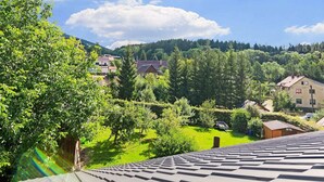 A residential area with houses, trees, and a clear sky. - Mountain Home With Garden (Cerny Dul)