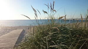 A wooden boardwalk leading to a beach with tall grasses in the foreground. - Apartment in Detershagen With Terrace (Kroepelin)