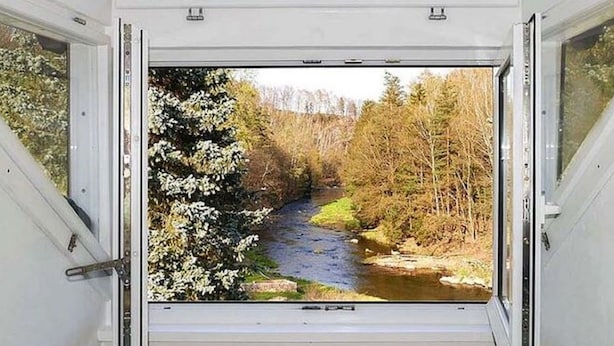 A room with a large window overlooking a river and forest. - Exclusive Apartment in an art Nouveau Villa (Grossschirma)