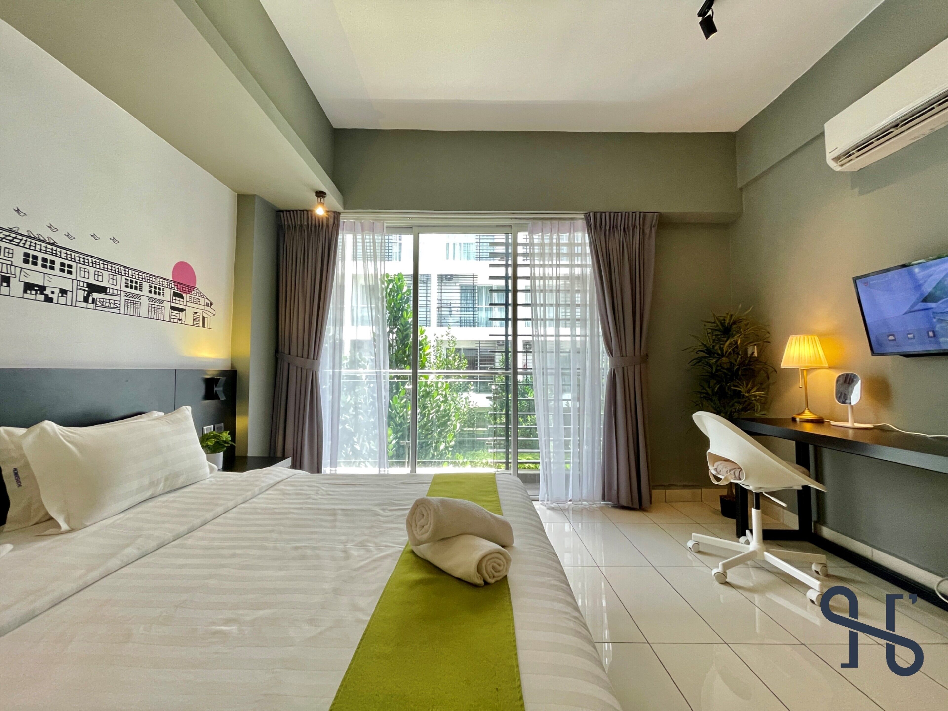 A hotel room with a large bed, a desk with a chair, a TV, and a window with curtains.