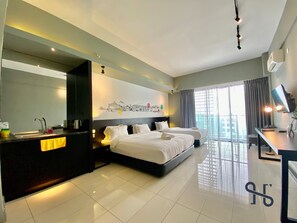 A modern hotel room with a large bed, a desk, a flat-screen TV, and a cityscape artwork on the wall. -  Homesuite' Home at Aeropod SOVO (Kota Kinabalu)