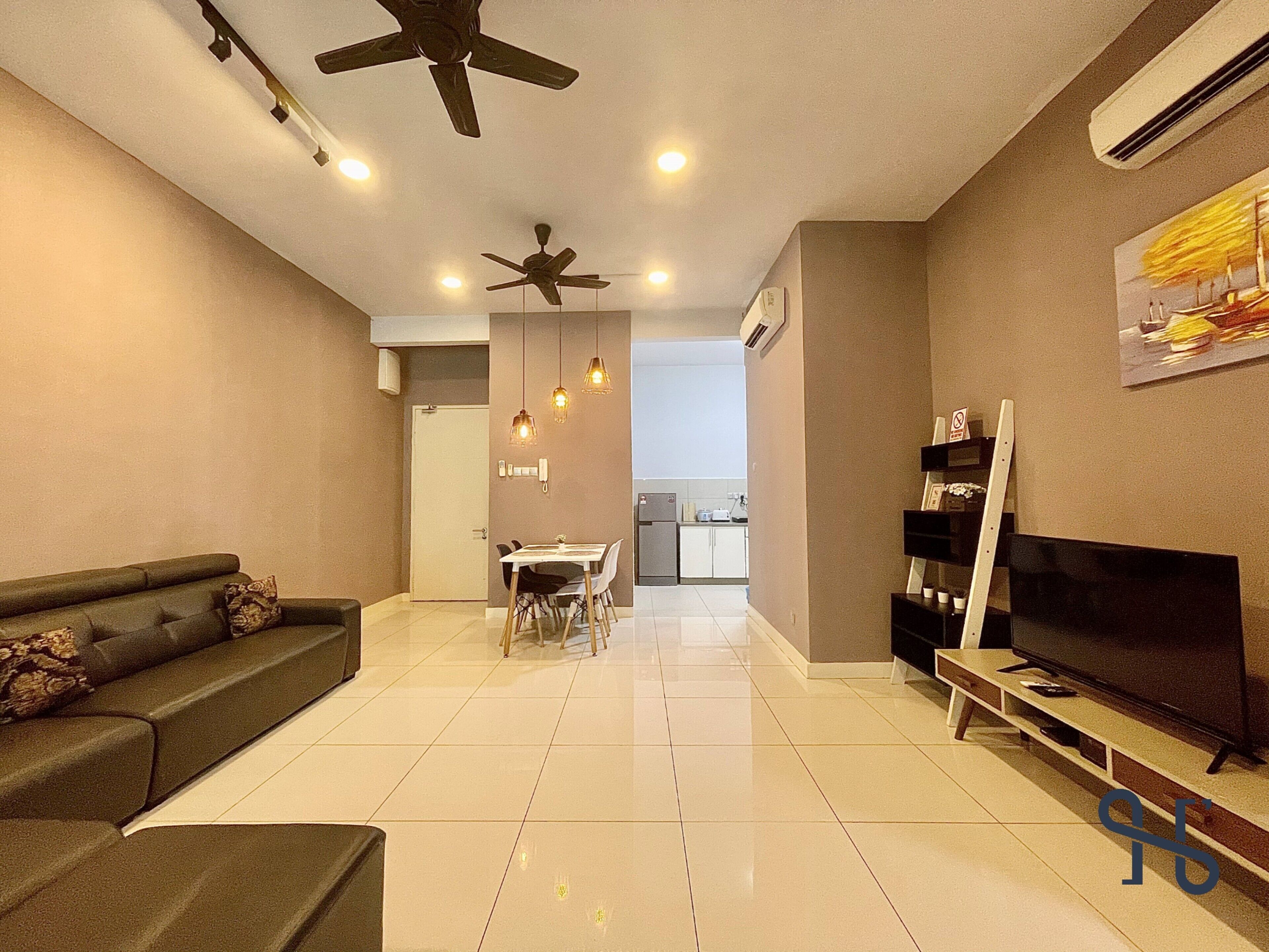 A modern living room with a sofa, TV, ceiling fans, and a dining area with chairs and a table.