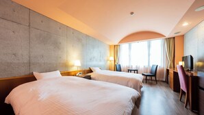 A hotel room with two beds, a desk, a chair, a television, and a large window with curtains. - BEPPU DOG RESORT HILLS & BAY (Beppu)