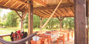 An outdoor wooden pavilion with benches and a fire pit. - Mush Rooms (Higashikawa)