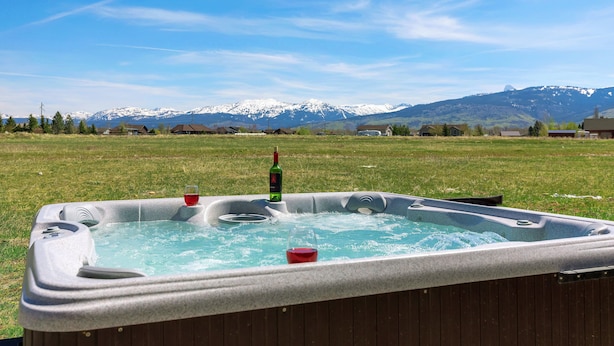 A hot tub in a grassy field with a mountain backdrop. - Teton Harmony (Driggs)