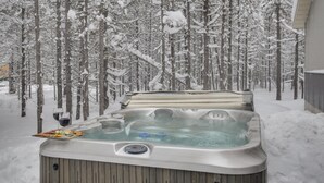 A hot tub surrounded by a snowy forest. - Buck Buck Moose (Island Park)