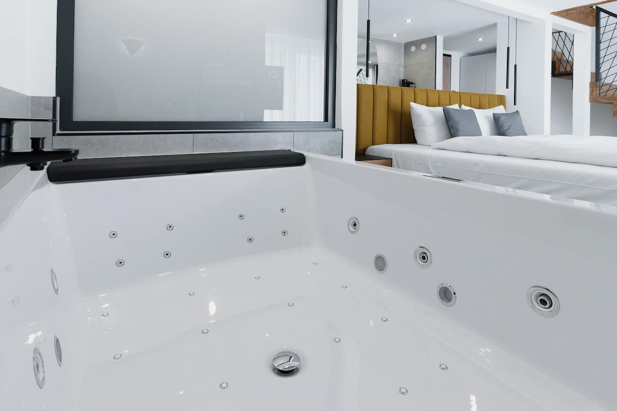 junior suite, jetted tub | 1 bedroom, down duvets, in-room safe, desk