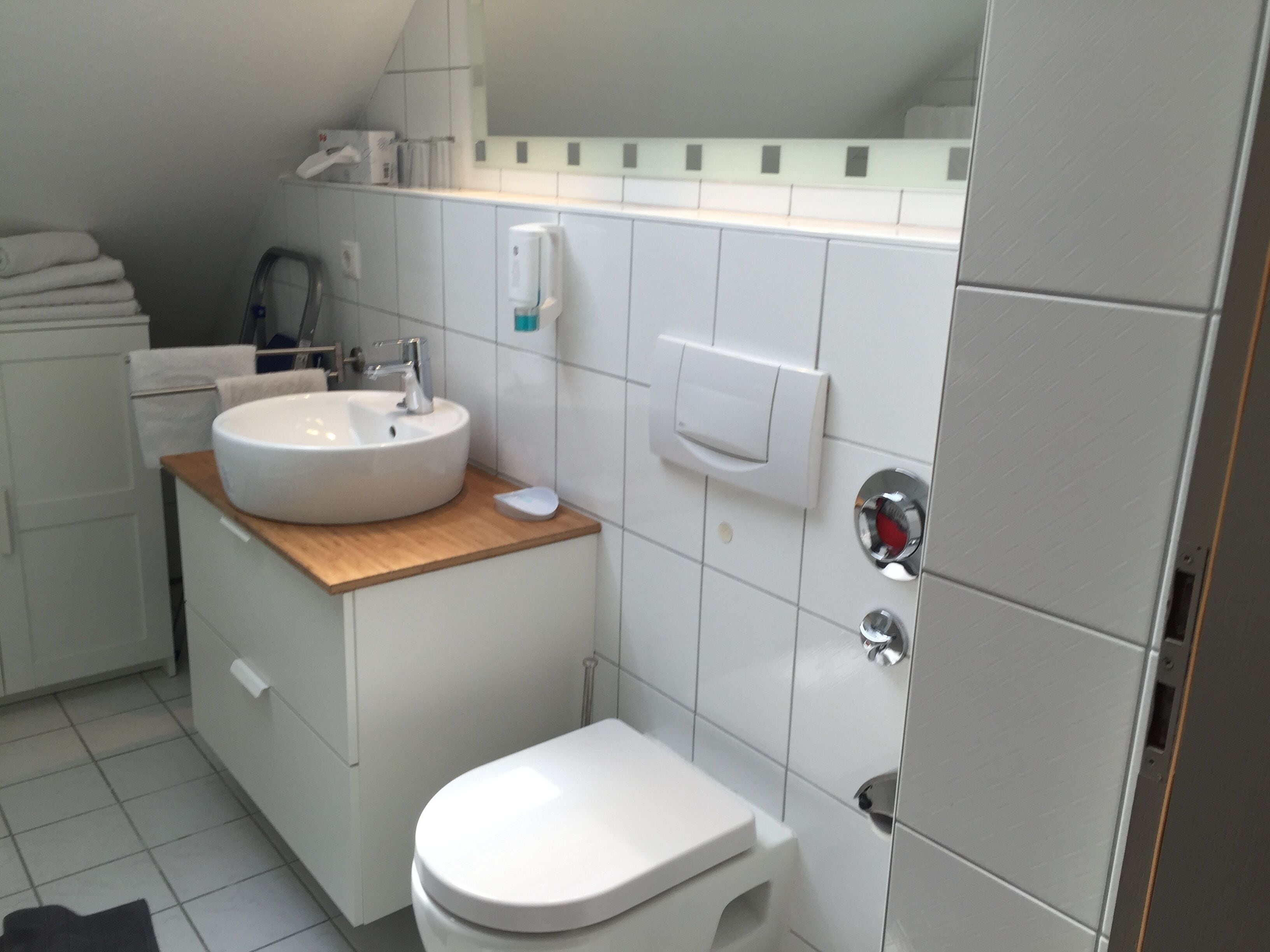 A bathroom with a white sink, a toilet, and a towel rack.