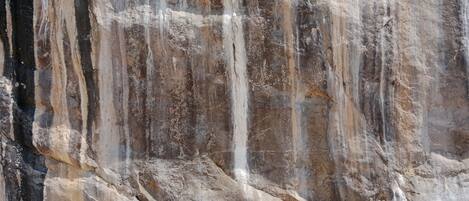 A large rock formation with a waterfall.