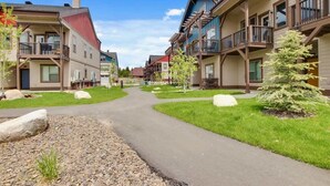 A residential area with multi-story buildings, a central pathway, and well-maintained lawns. - Alluring Farmhouse Styled Town Home (McCall)