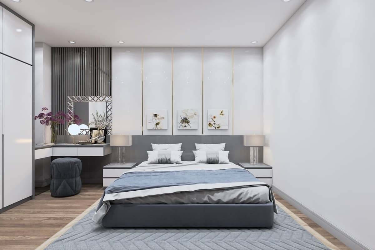 Een moderne slaapkamer met een bed, nachtkastjes, een bureau en een stoel.