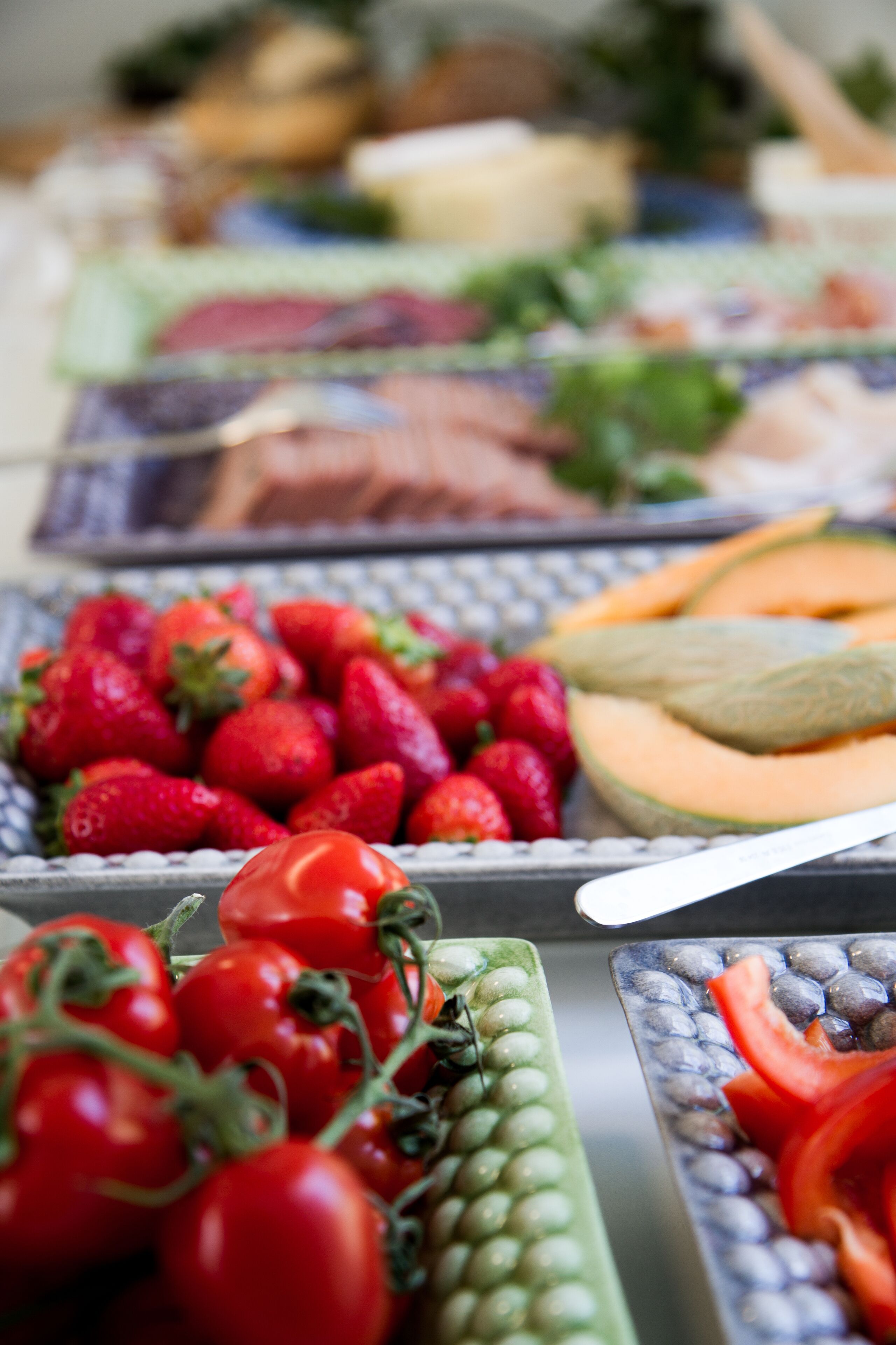 A variety of fresh fruits and vegetables displayed on trays.