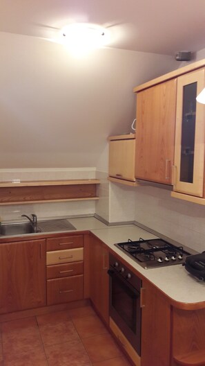 Departamento superior, 1 habitación | Cocina privada | Refrigerador, horno, parrilla de estufa y cafetera y tetera 