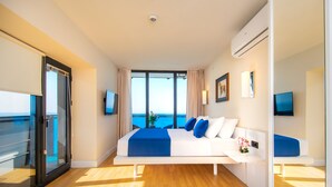 A modern hotel room with a large bed, a balcony, and a view of the sea. - Orbi City Hotel Official (Batumi)