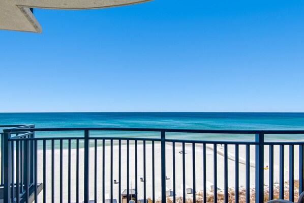 A beach view with a clear sky, a sandy beach, and a railing. - GULF FRONT CONDO! 3BR/3BA! MASTER BEDROOM WITH GULF VIEWS! (Panama City Beach)