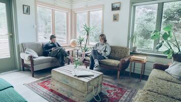 A cozy living room with two sofas, a coffee table, and a globe.