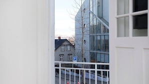 A view of a modern building with large windows and a parking sign. - Stunning 2BR apt with balcony view in Reykjavik (Reykjavík)