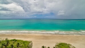 A beach with clear turquoise water and a sandy shore. - Oceanfront Luxury Escape  (Carolina)