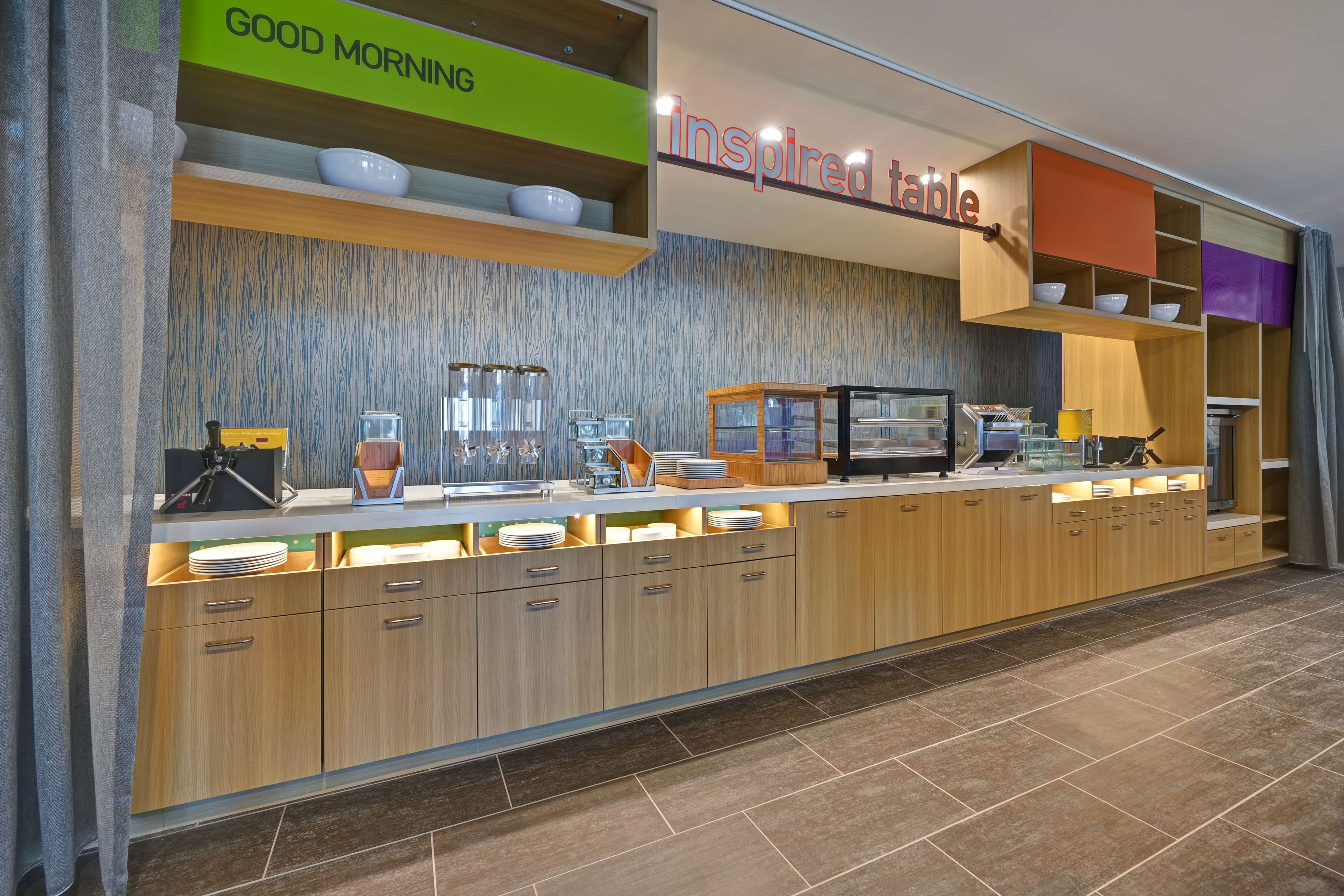 A modern breakfast bar with a 'Good Morning' sign and an 'Inspired Table' sign.