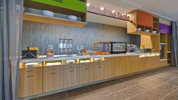 A modern breakfast bar with a 'Good Morning' sign and an 'Inspired Table' sign.