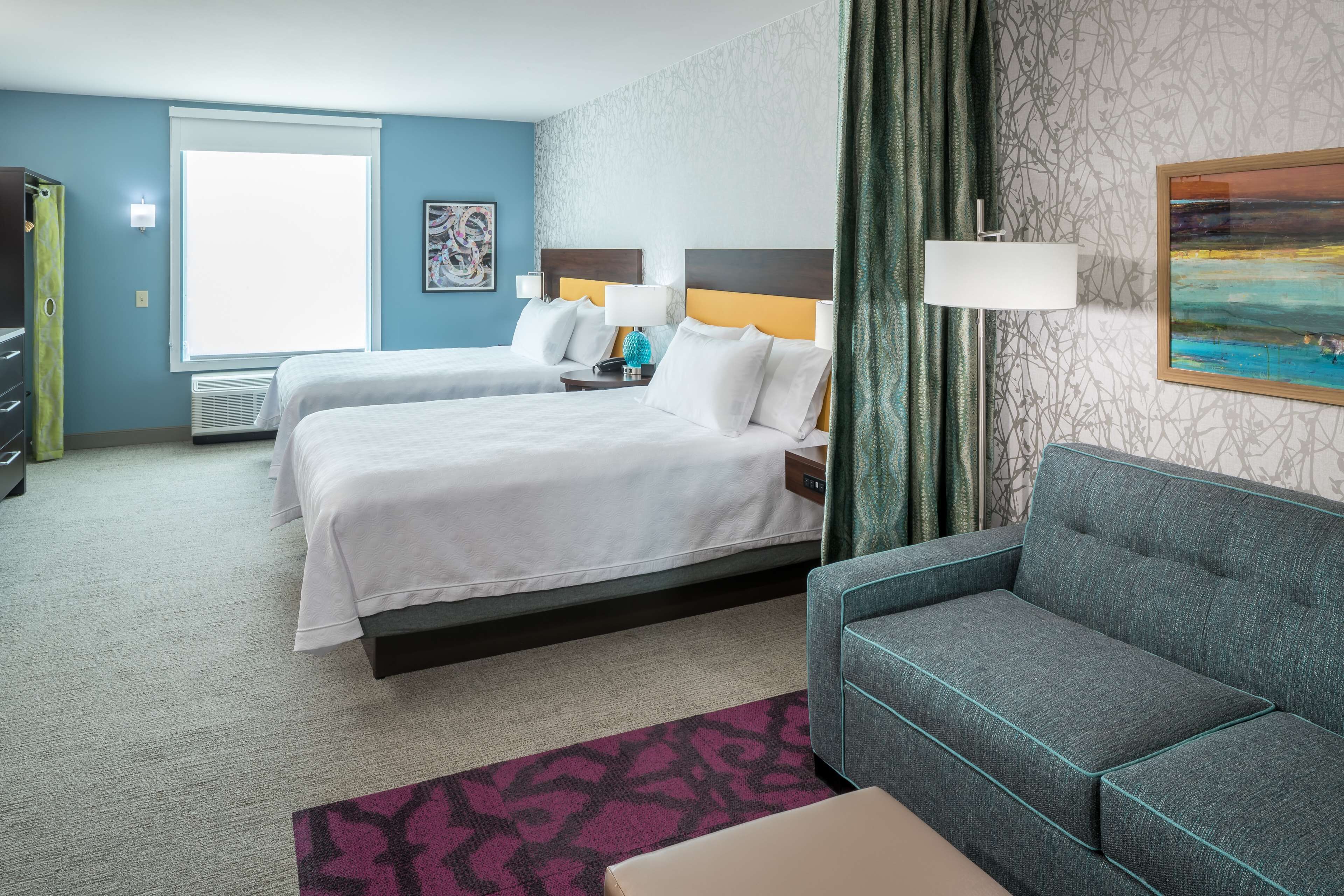 desk, laptop workspace, iron/ironing board, bed sheets