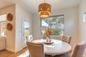 Enjoy meals with a view of the surrounding mountains from this dining area with a round table and comfortable seating for four.