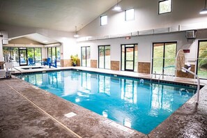 Relax by the pool surrounded by comfortable seating and a lifeguard on duty.