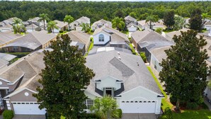 A residential area with houses featuring sloped roofs and front yards.