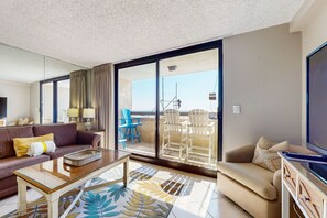 Relax on the balcony with a view of the sky and a distant structure, or unwind in the spacious room with a comfortable sofa and flat-screen TV.