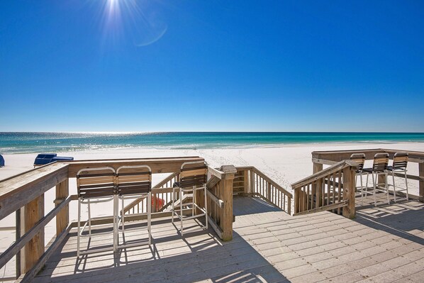 Walk along the beach on a wooden boardwalk lined with seating.