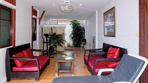A modern interior with a seating area, a fan, and a view into another room. - Busaba Villa 7 - 3 Bedroom - Pool (Tambon Nong Kae)