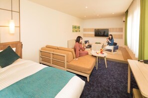 Relax in a spacious room with a large bed, sofa bed, and flat-screen TV.