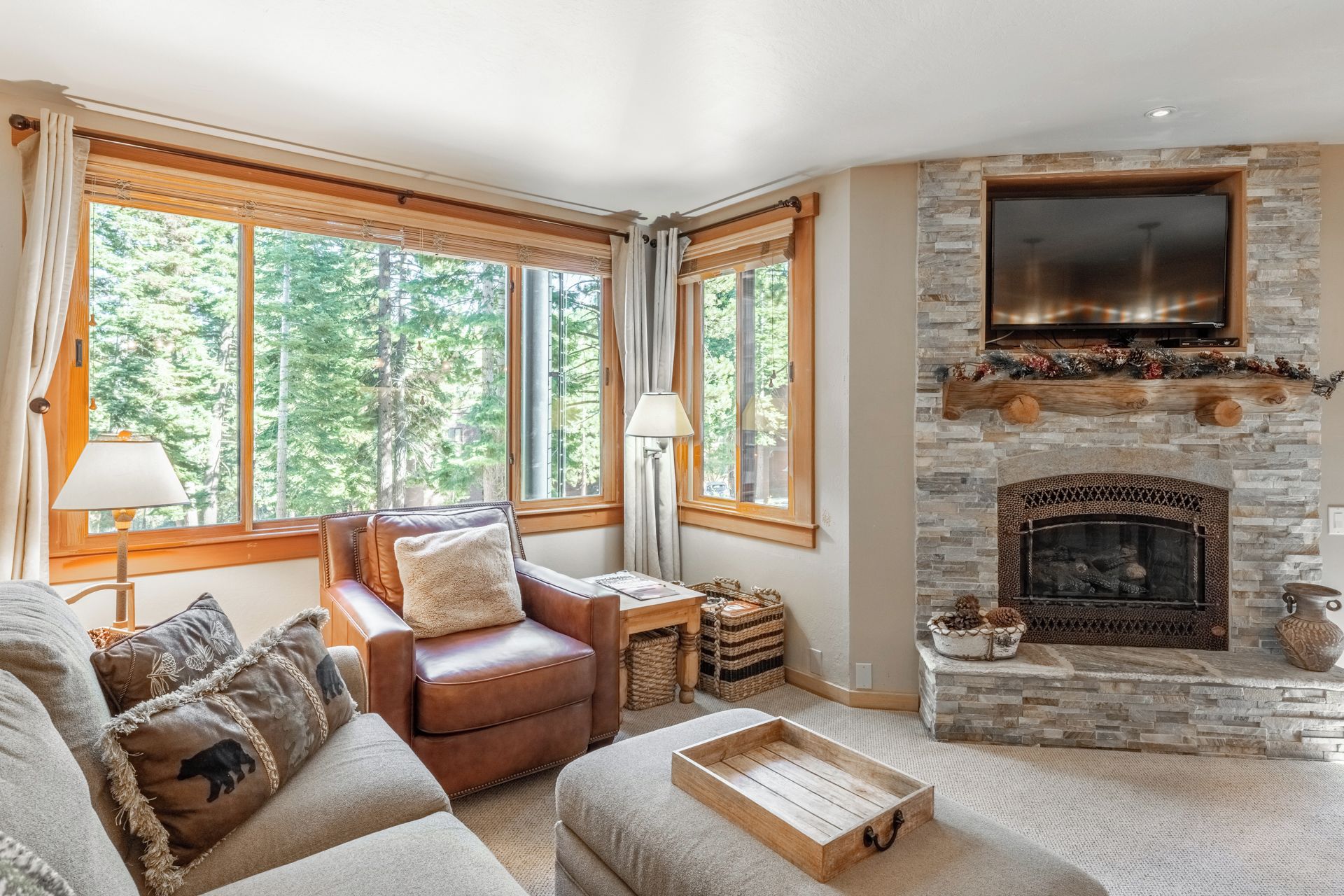Curl up by your cozy stone fireplace and gaze out at the peaceful forest views—your perfect mountain retreat awaits.