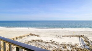 A beach with a wooden boardwalk and sandy dunes. - Beachfront 1BR @ Phoenix I • Sleeps 6 • Stunning Views, Pool, Splash Pad & Beach Access (Orange Beach)